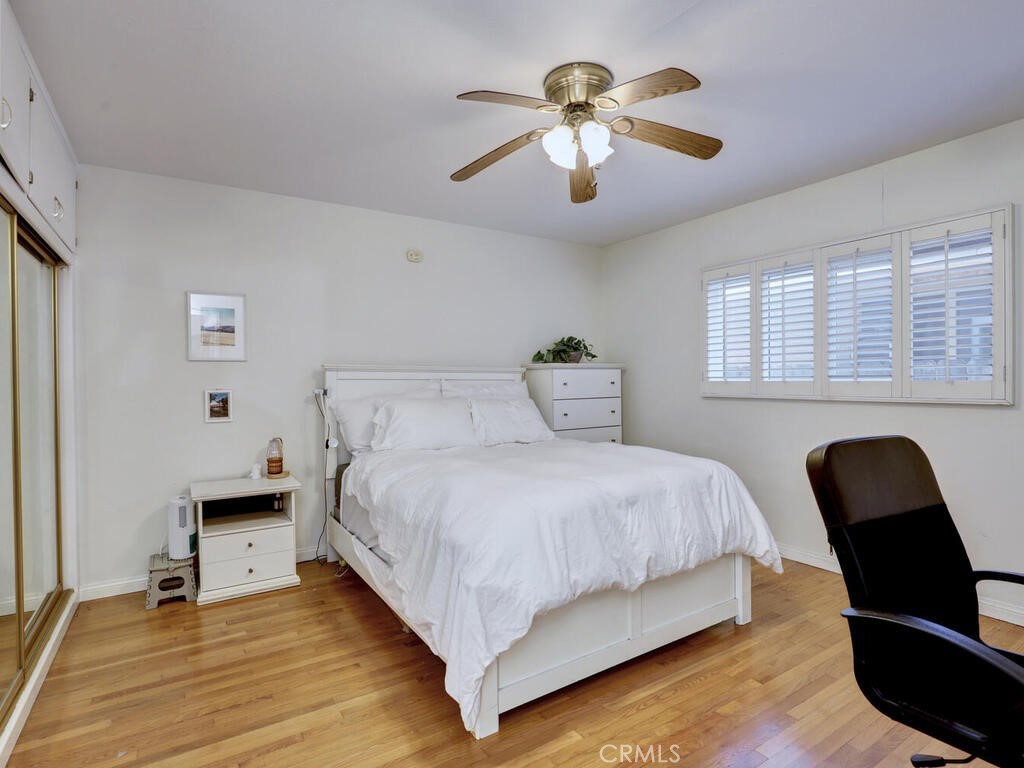 3042 East 3rd Street, Unit 5 Long Beach, CA 90814 - Photo 19 of 25 a bedroom with a bed and a chair