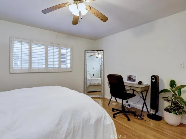 a bedroom with furniture and a chair