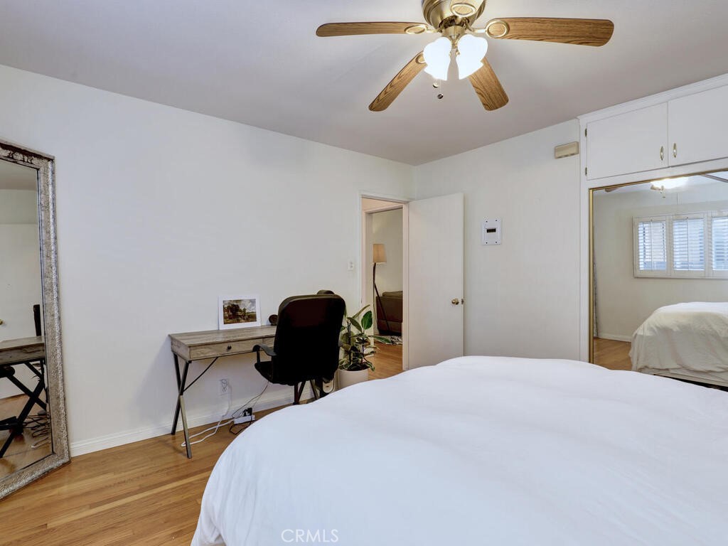 3042 East 3rd Street, Unit 5 Long Beach, CA 90814 - Photo 21 of 25 a bedroom with a bed and a chandelier