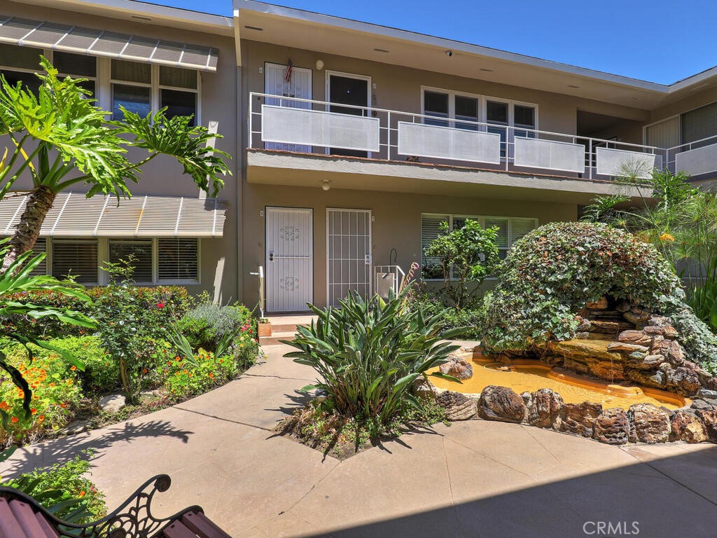 3042 East 3rd Street, Unit 5 Long Beach, CA 90814 - Photo 5 of 25 a front view of a house with a yard