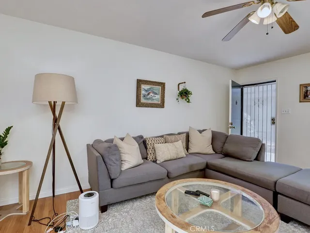 a living room with furniture and a wooden floor