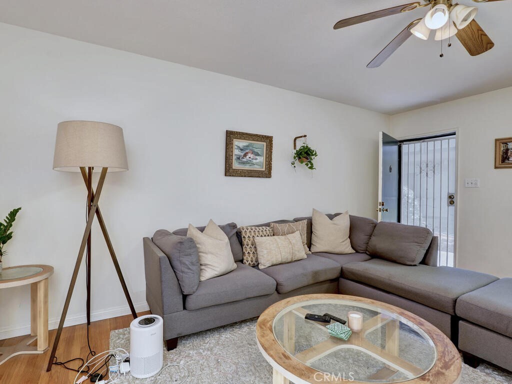 3042 East 3rd Street, Unit 5 Long Beach, CA 90814 - Photo 9 of 25 a living room with furniture and a wooden floor