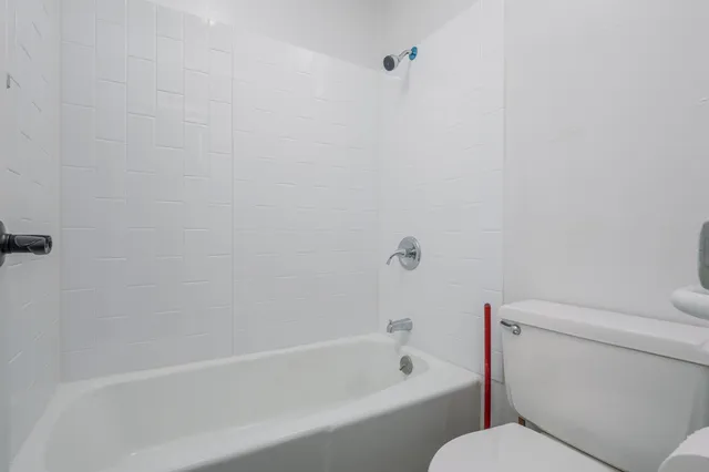 a bathroom with a toilet and a bathtub