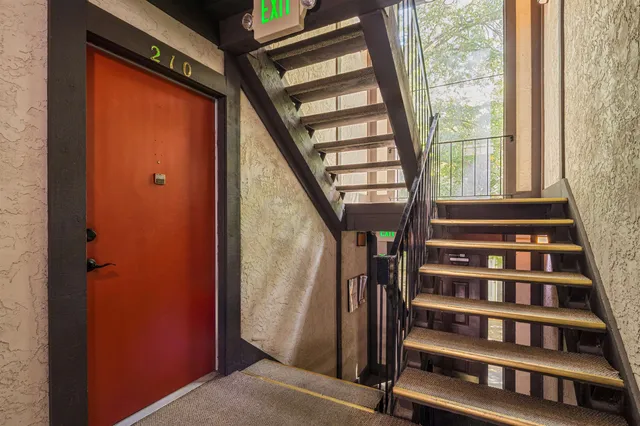 a view of staircase with wooden floor and windows
