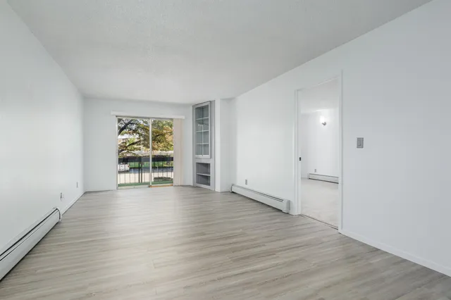 wooden floor in an empty room with a window