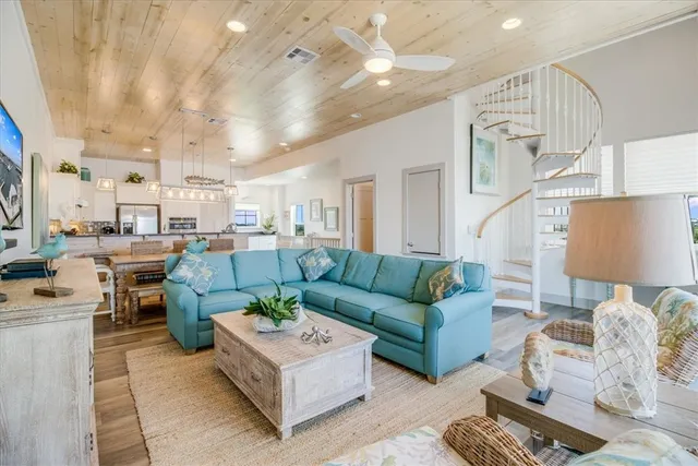 a living room with furniture and a view of kitchen
