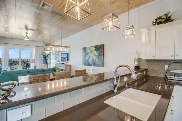 a kitchen with a sink appliances and a counter top space