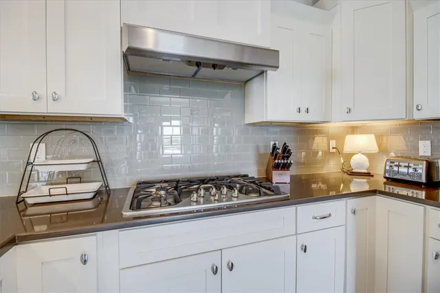 a kitchen with a sink a stove and cabinets