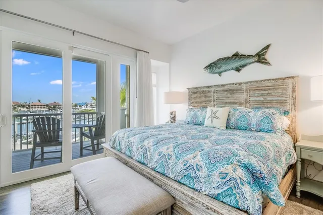 a bedroom with a large bed and a chandelier