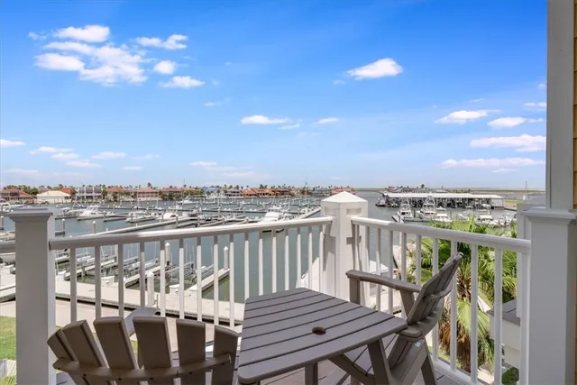 a view of a balcony with wooden floor and city view