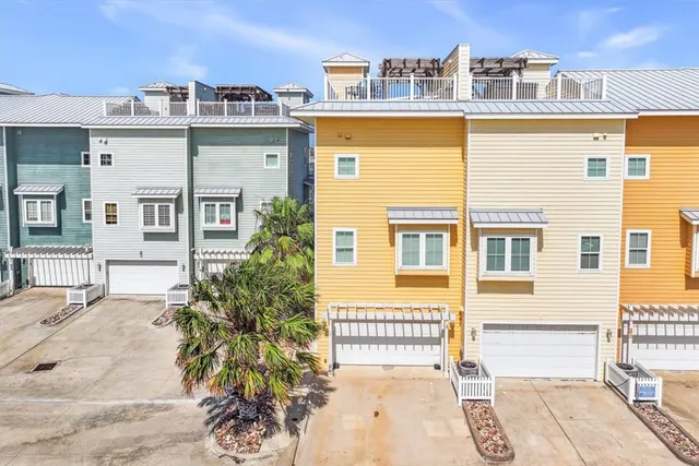 a front view of a residential apartment building with a yard and balcony