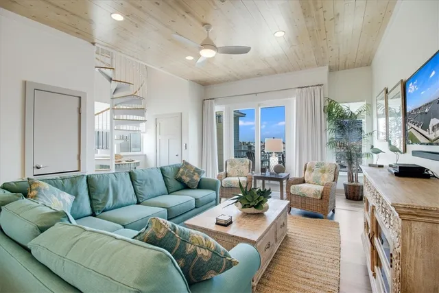 a living room with furniture fireplace and a large window