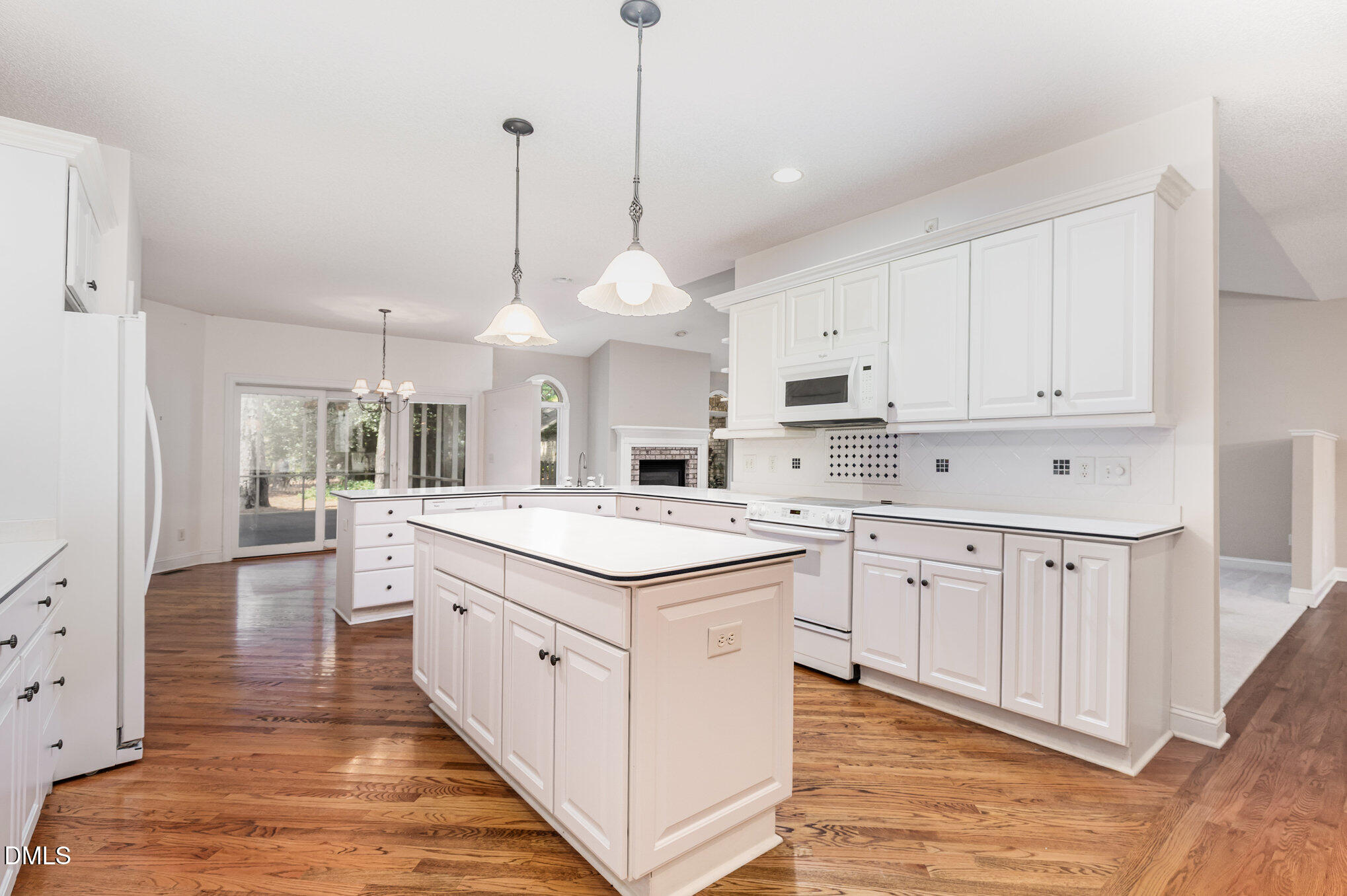 5 Pinyon Lane Pinehurst, NC 28374 - Photo 21 of 37 a kitchen with white cabinets and white appliances