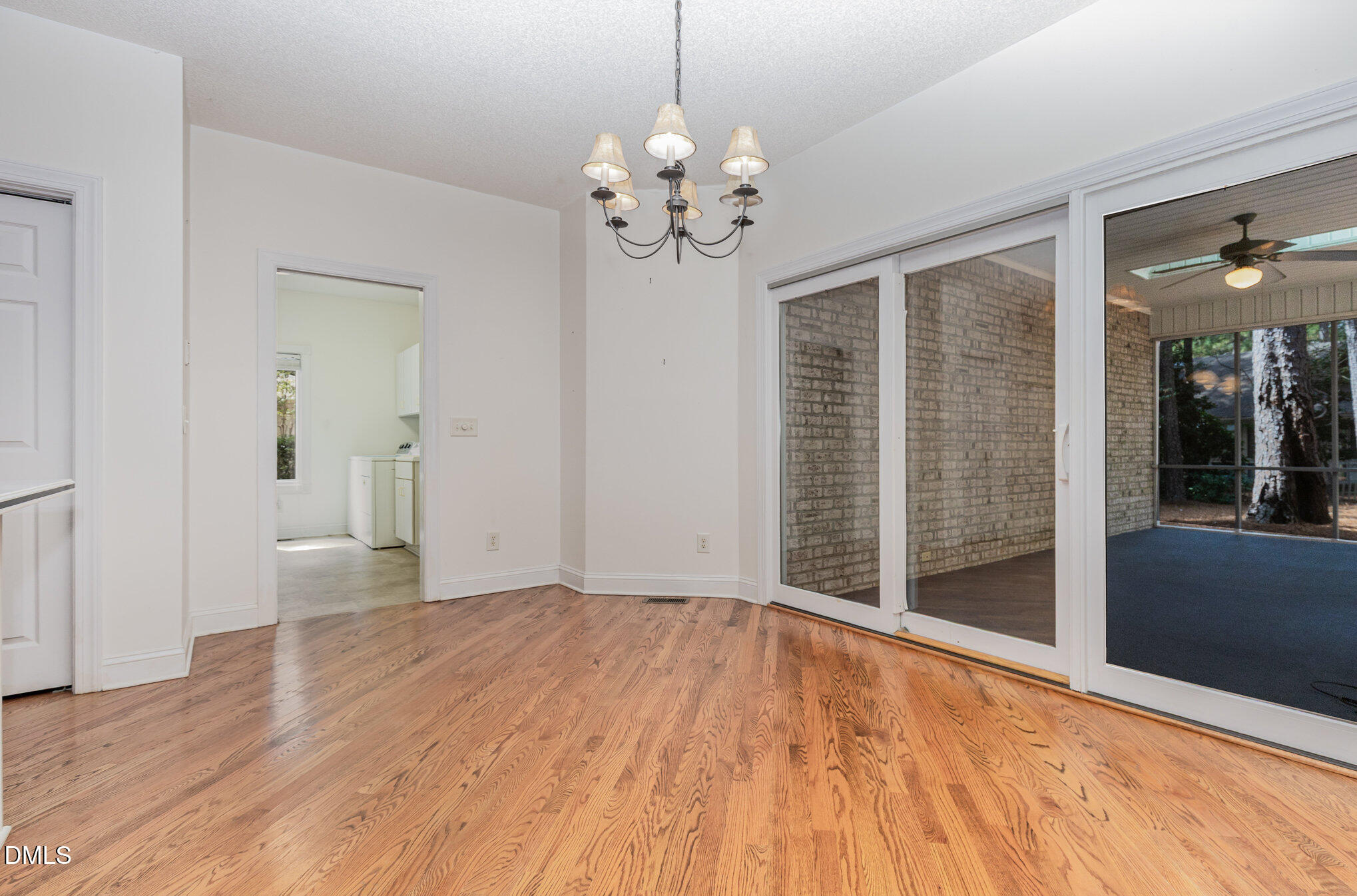 5 Pinyon Lane Pinehurst, NC 28374 - Photo 22 of 37 a view of an empty room with wooden floor and a window