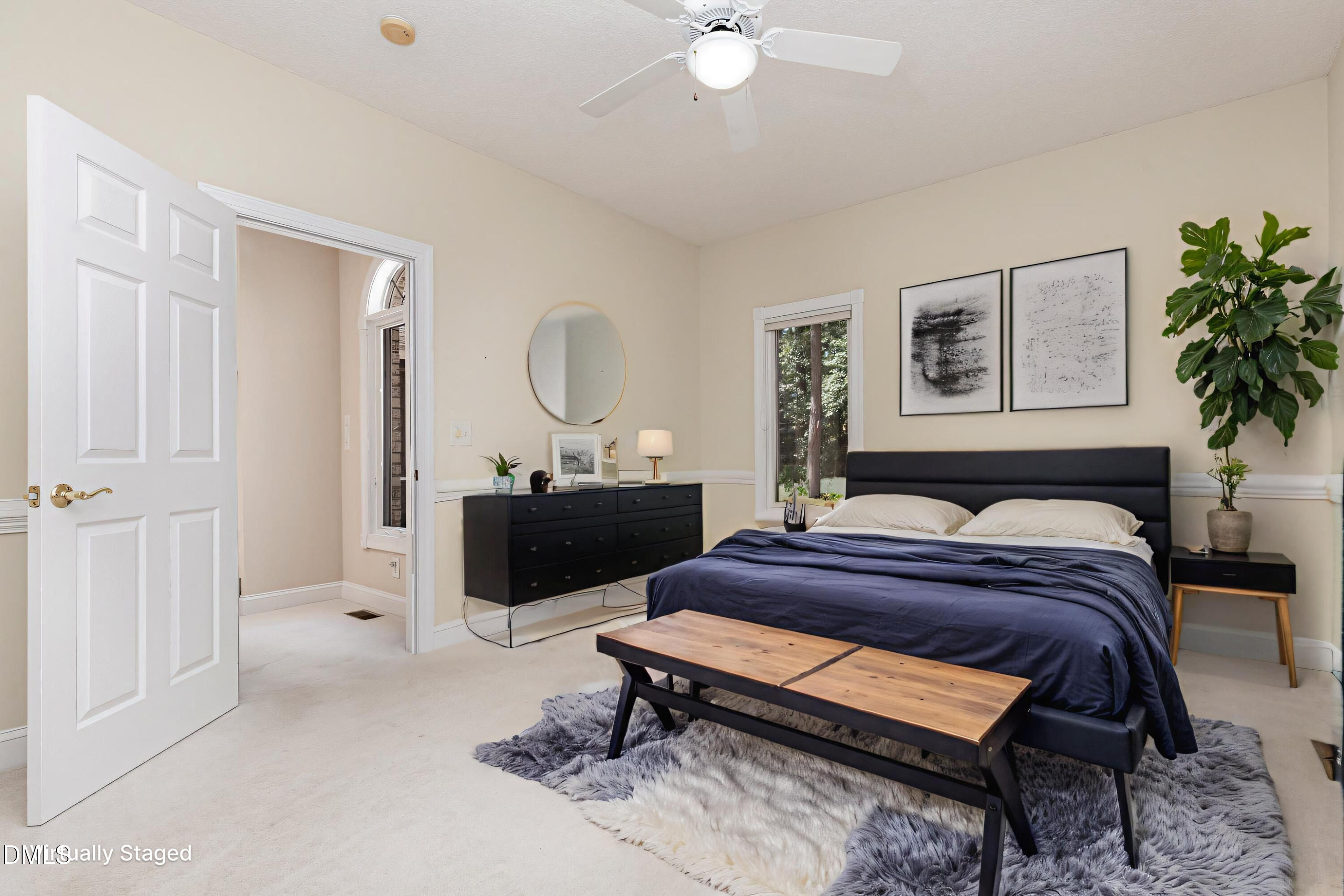 5 Pinyon Lane Pinehurst, NC 28374 - Photo 23 of 37 a bedroom with a bed a potted plant and a dresser
