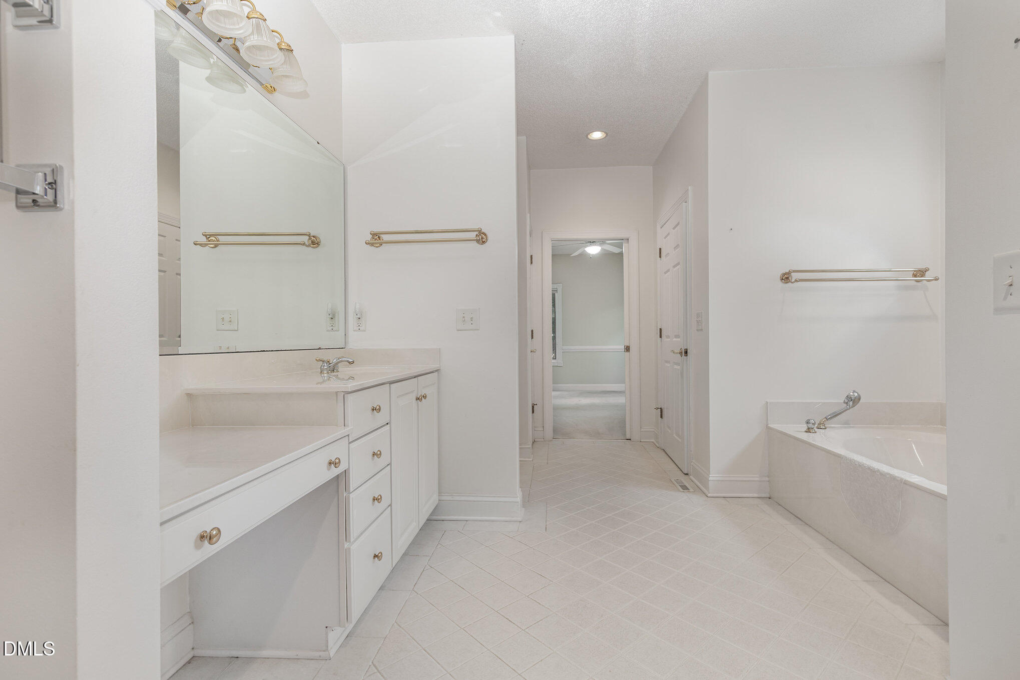 5 Pinyon Lane Pinehurst, NC 28374 - Photo 27 of 37 a spacious bathroom with a double vanity sink a mirror and a bathtub