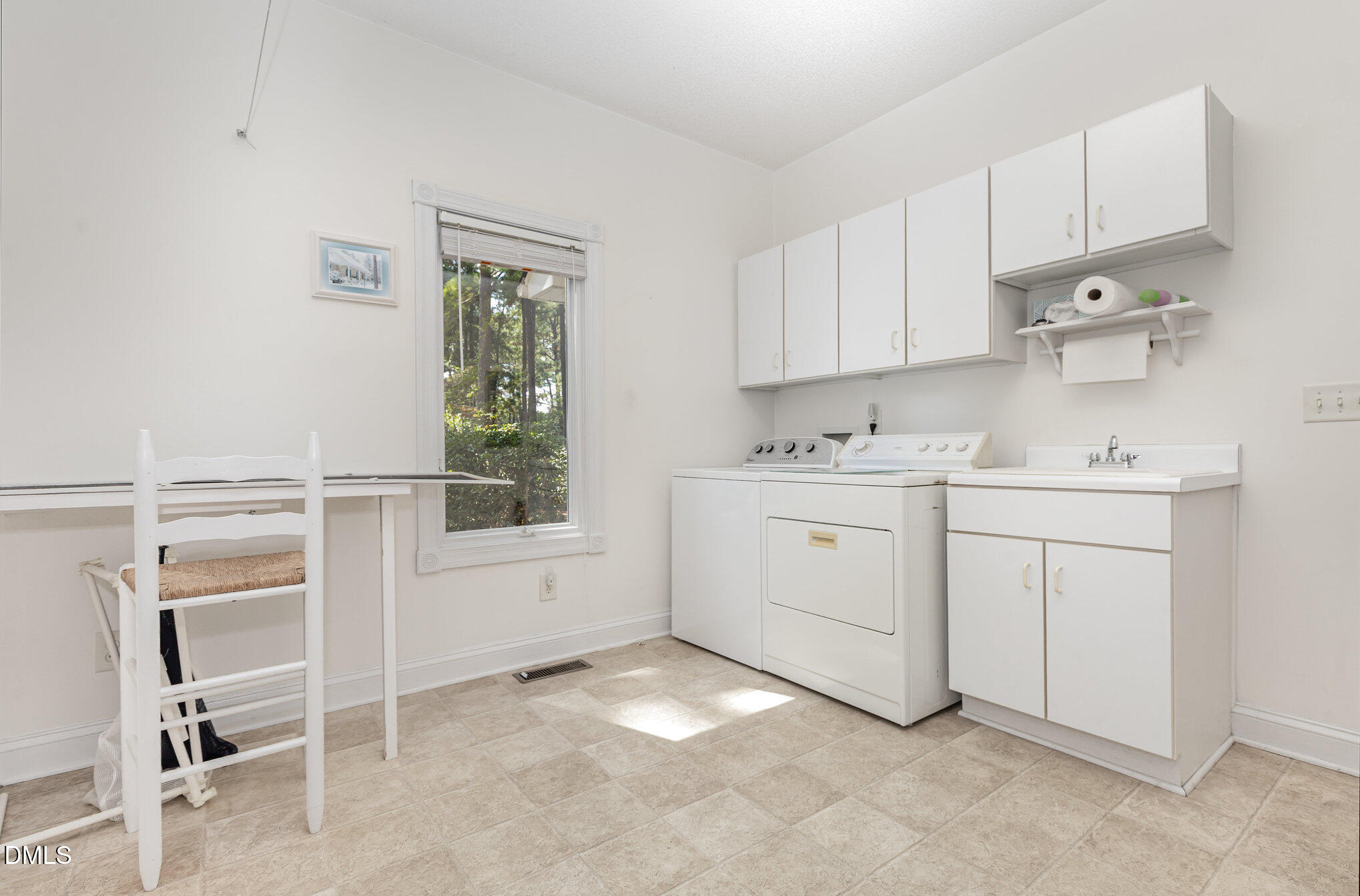 5 Pinyon Lane Pinehurst, NC 28374 - Photo 31 of 37 a utility room with cabinets washer and dryer