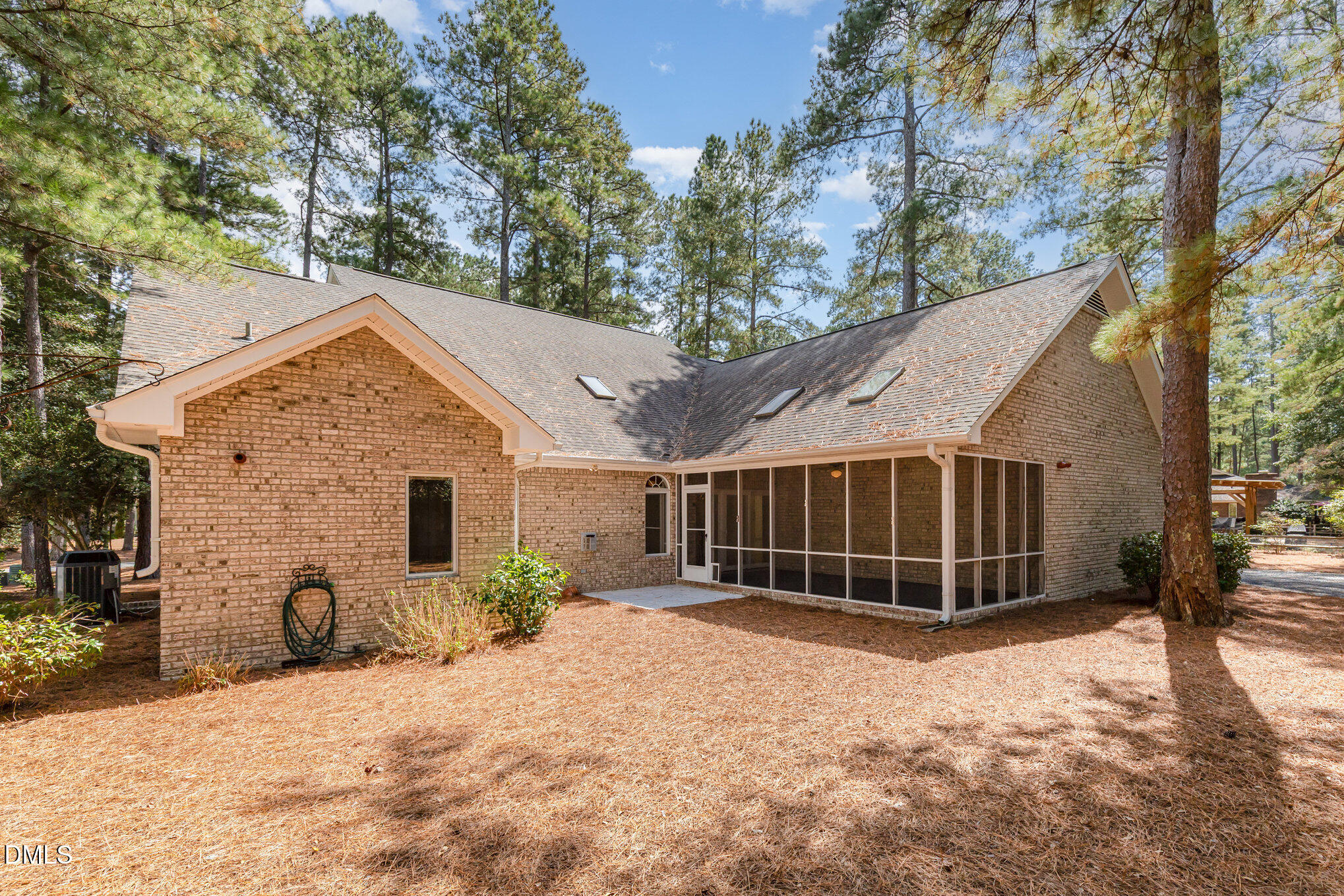 5 Pinyon Lane Pinehurst, NC 28374 - Photo 36 of 37 a view of backyard with large trees and potted plants