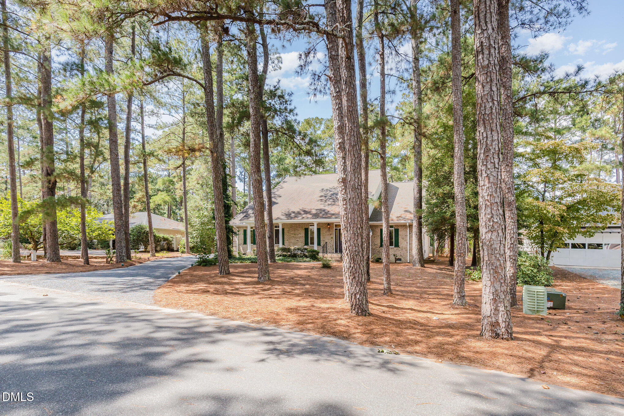 5 Pinyon Lane Pinehurst, NC 28374 - Photo 4 of 37 a front view of a building with a tree in front