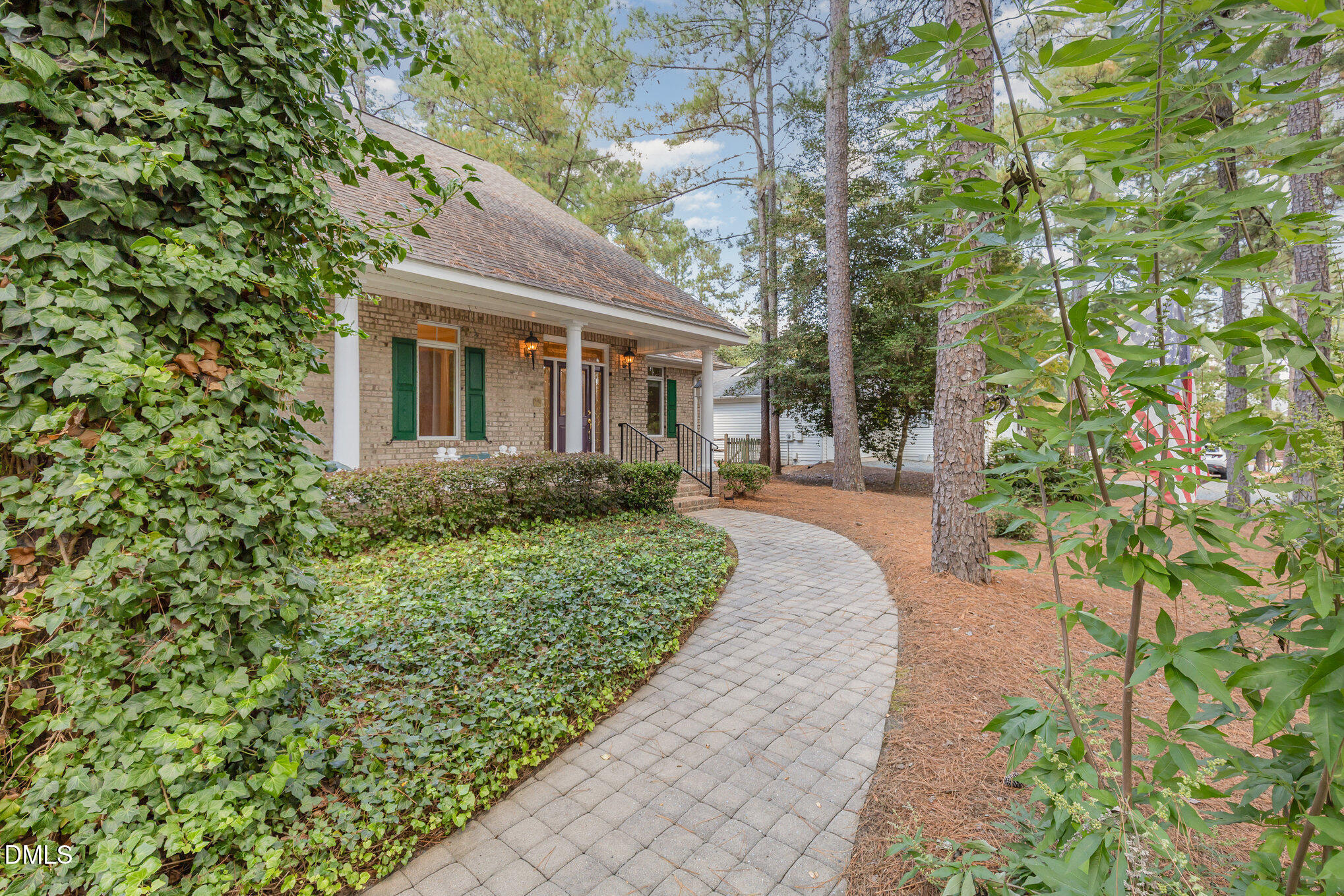 5 Pinyon Lane Pinehurst, NC 28374 - Photo 9 of 37 a front view of a house with a yard and trees