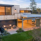 a backyard of a house with table and chairs