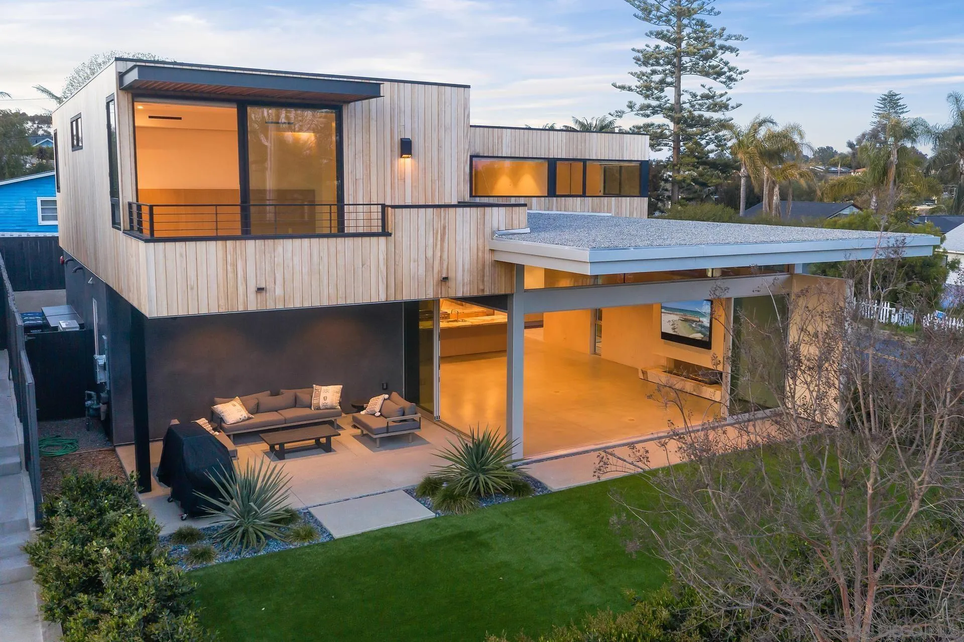 a backyard of a house with table and chairs