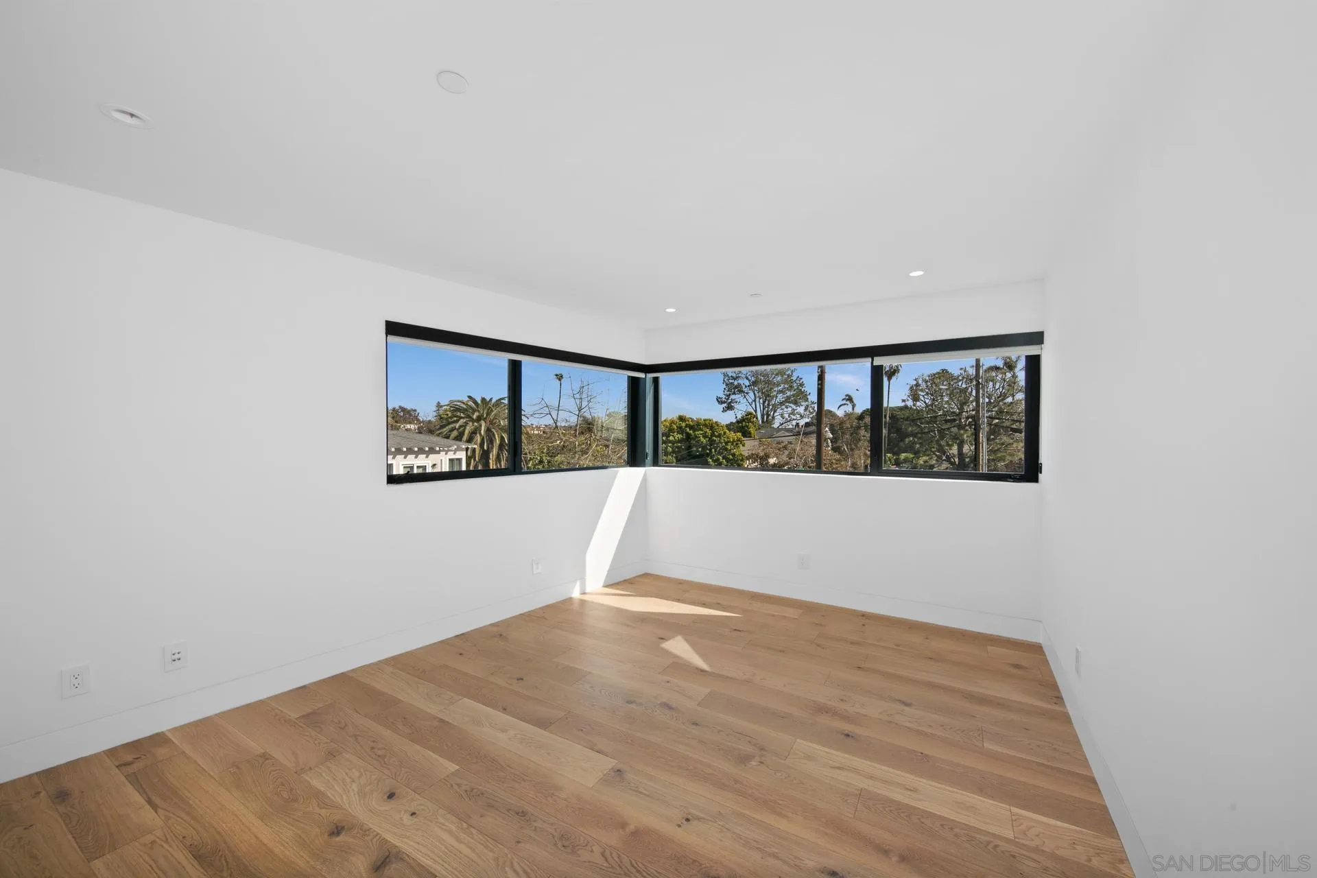 664 Cornish Drive Encinitas, CA 92024 - Photo 13 of 49 a view of an empty room with wooden floor and windows