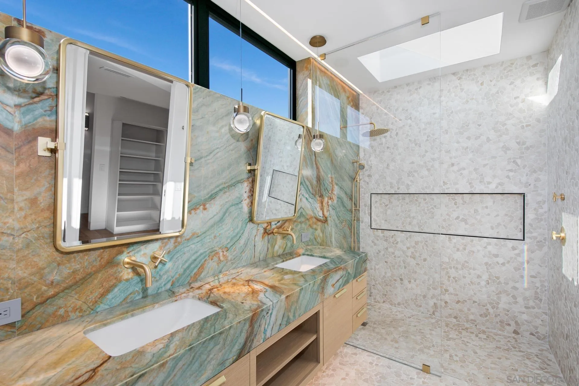 664 Cornish Drive Encinitas, CA 92024 - Photo 24 of 49 a bathroom with a granite countertop sink a mirror and shower