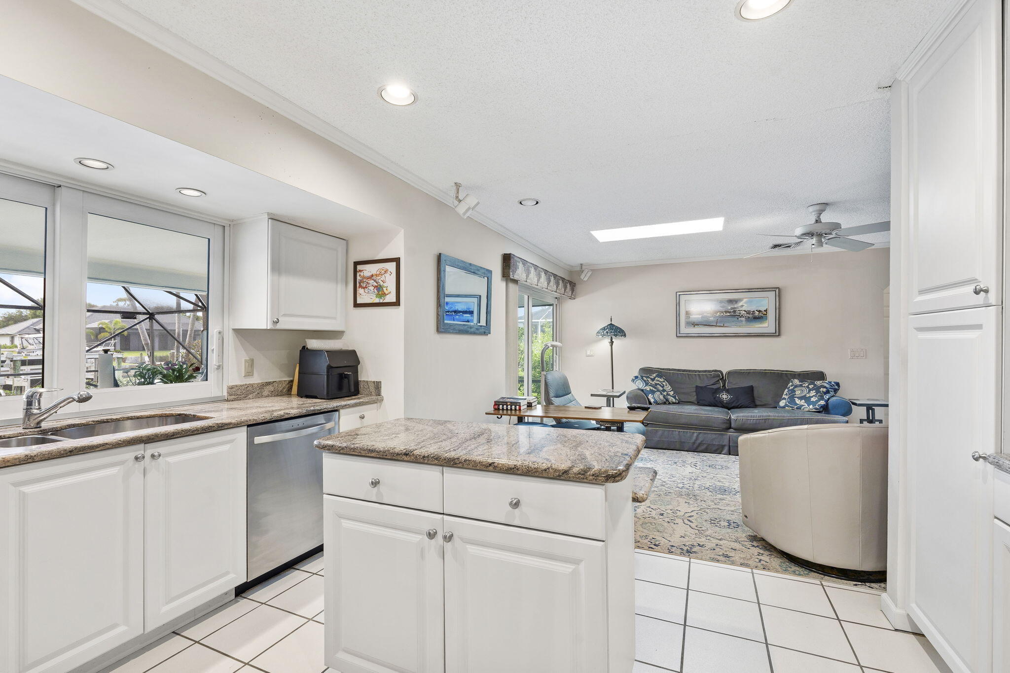 3374 Southeast Fairway East Stuart, FL 34997 - Photo 16 of 65 a kitchen with granite countertop a sink and cabinets