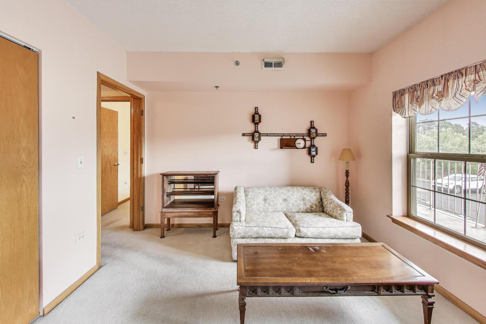 1200 South Prospect Avenue, Unit 108 Elmhurst, IL 60126 - Photo 11 of 19 a bedroom with furniture and a window