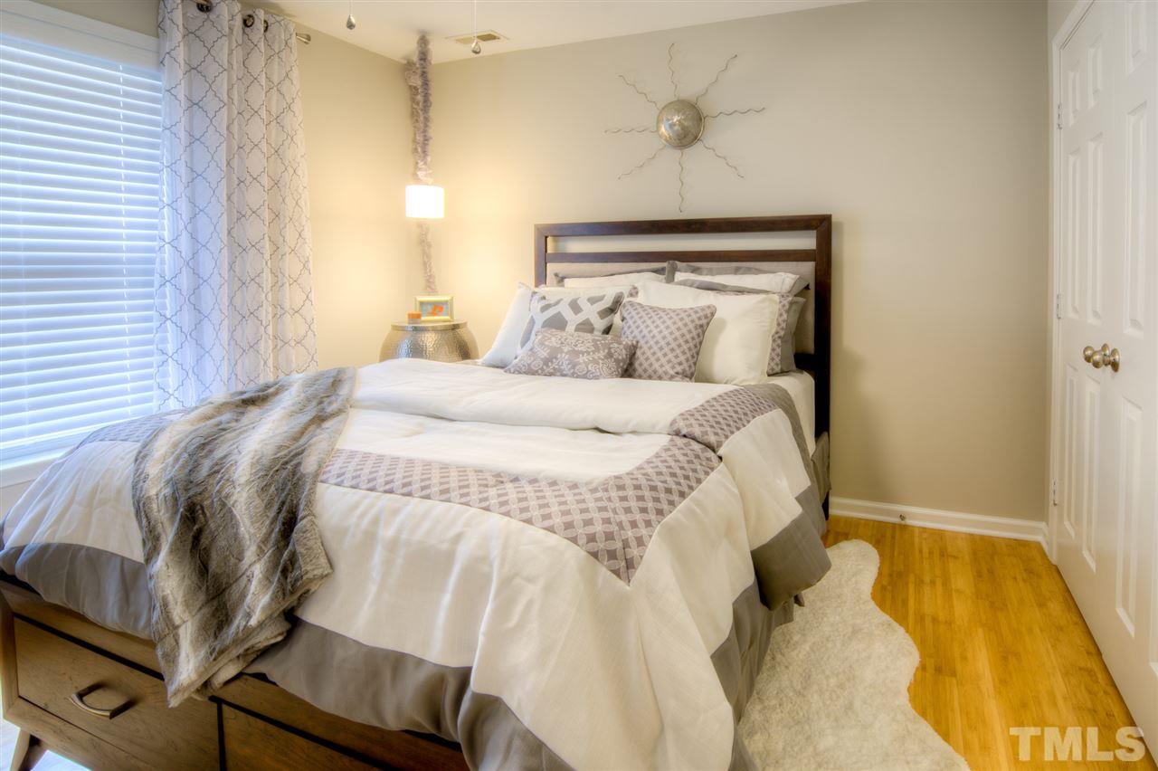 1308 South State Street, Unit D Raleigh, NC 27610 - Photo 4 of 4 a bedroom with a bed and lamps