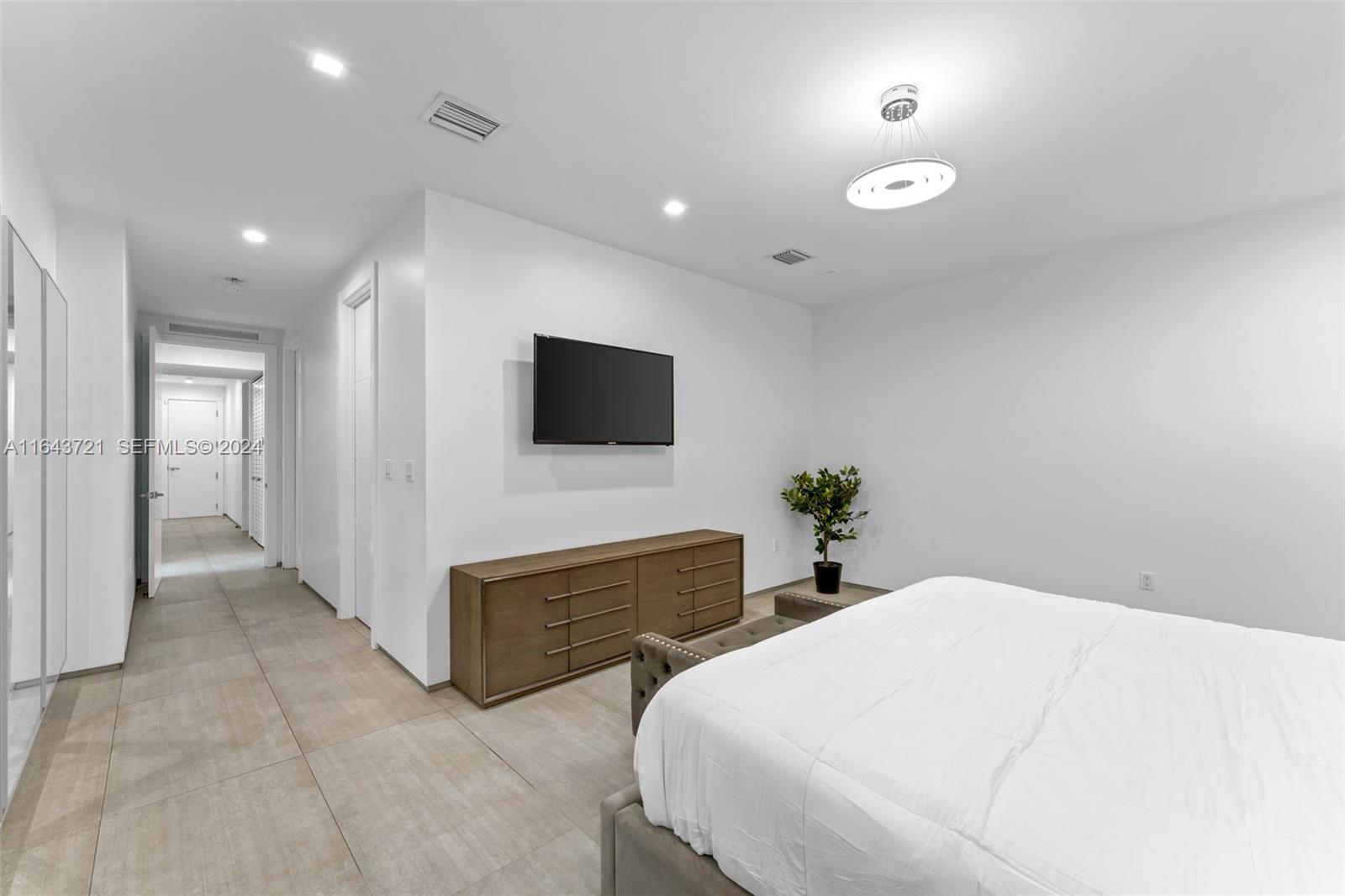 1510 Southwest 4th Avenue Miami, FL 33129 - Photo 17 of 46 a bedroom with bed and a flat tv screen on dresser