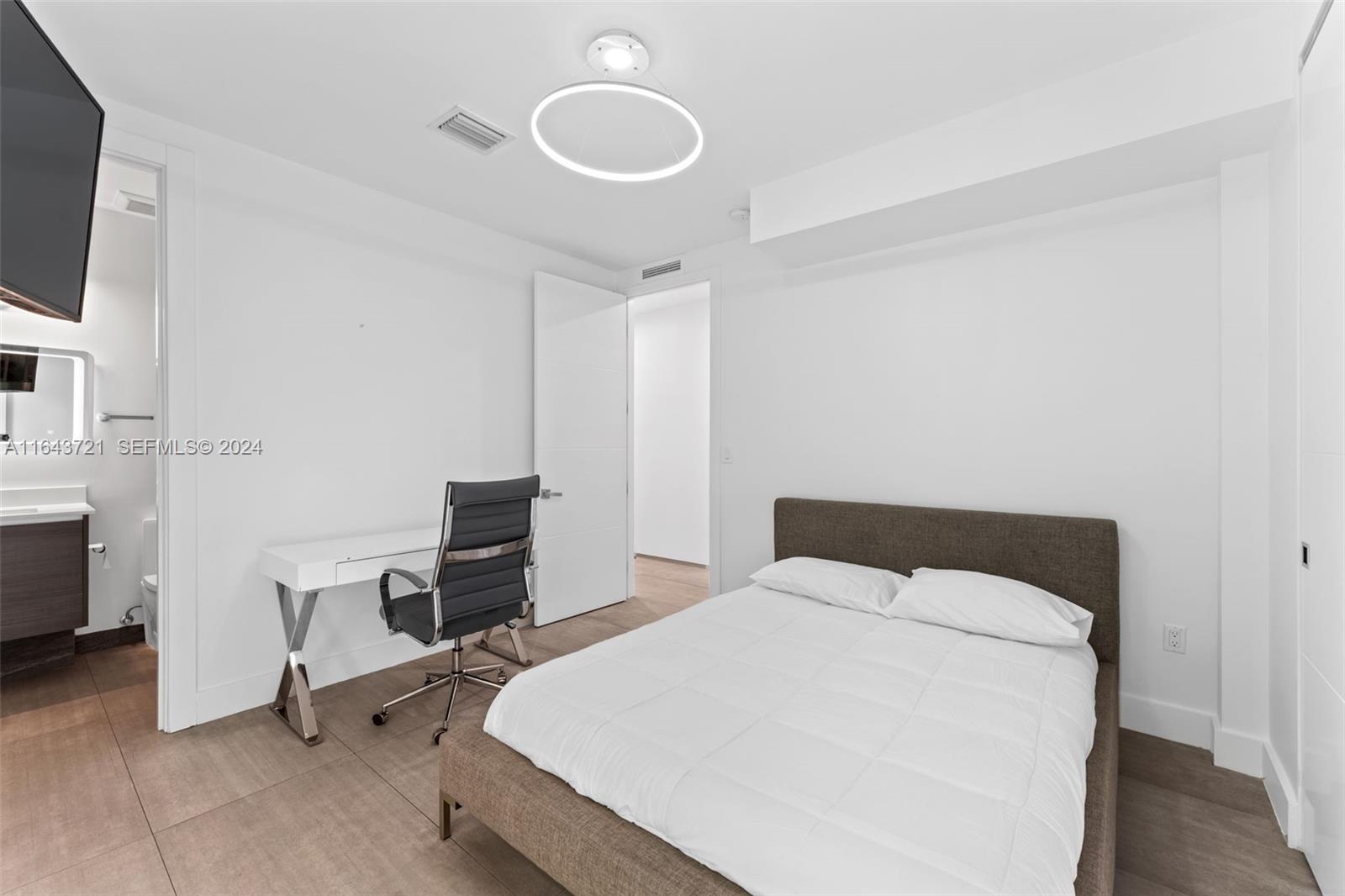 1510 Southwest 4th Avenue Miami, FL 33129 - Photo 24 of 46 a bedroom with a bed a desk and chair