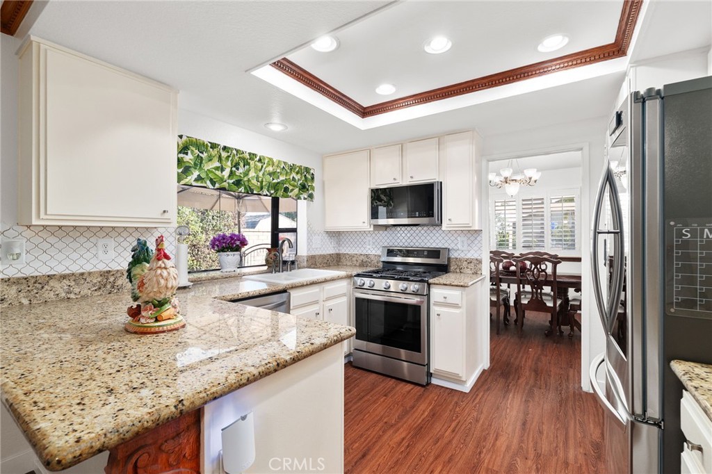 9637 Apricot Avenue Rancho Cucamonga, CA 91737 - Photo 13 of 44 a kitchen with stainless steel appliances granite countertop a sink stove and refrigerator