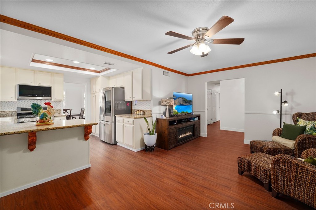 9637 Apricot Avenue Rancho Cucamonga, CA 91737 - Photo 16 of 44 a living room with furniture kitchen view and a chandelier