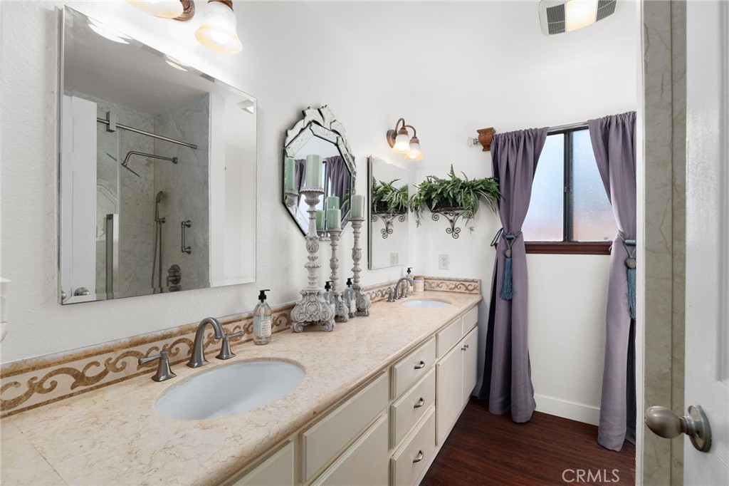 9637 Apricot Avenue Rancho Cucamonga, CA 91737 - Photo 21 of 44 a bathroom with a double vanity sink and mirror