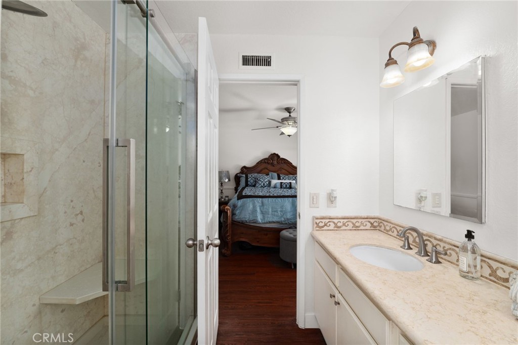9637 Apricot Avenue Rancho Cucamonga, CA 91737 - Photo 22 of 44 a en suite bathroom with a granite countertop sink and a mirror