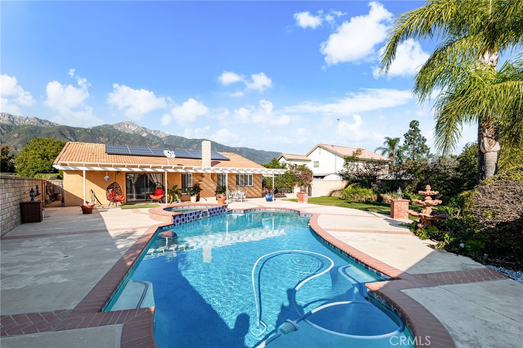 9637 Apricot Avenue Rancho Cucamonga, CA 91737 - Photo 3 of 44 a view of a swimming pool with lounge chairs