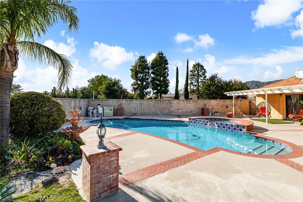 9637 Apricot Avenue Rancho Cucamonga, CA 91737 - Photo 32 of 44 a view of a backyard with swimming pool