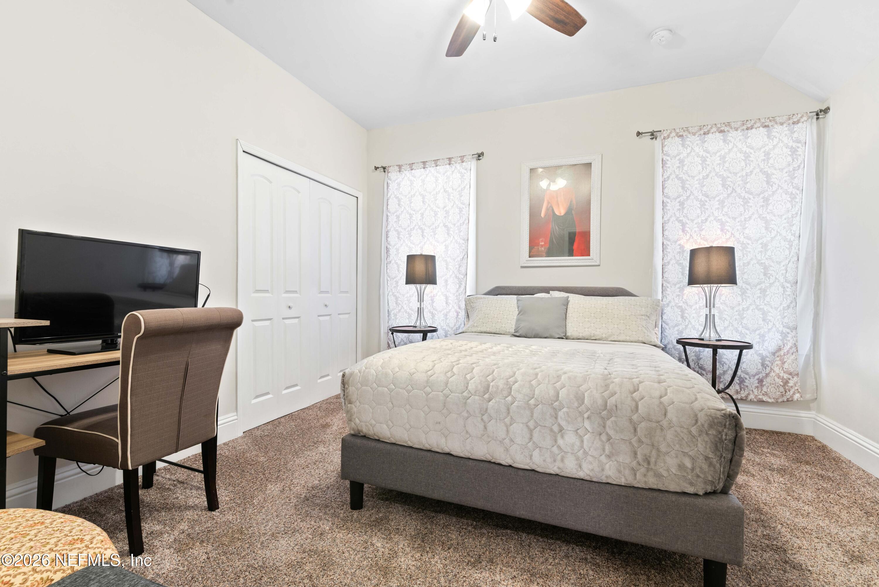 1138 Walnut Street Jacksonville, FL 32206 - Photo 16 of 37 a spacious bedroom with a bed and a table in it