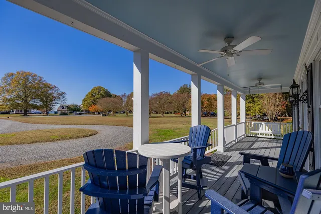 a kitchen with a stove a chandelier and wooden cabinets