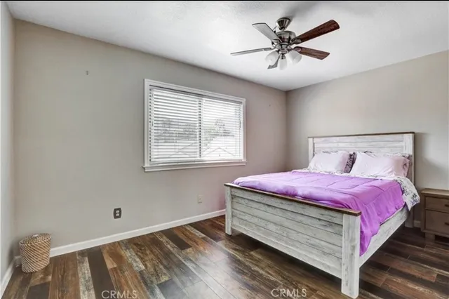 a view of a patio with a table and chairs under an umbrella