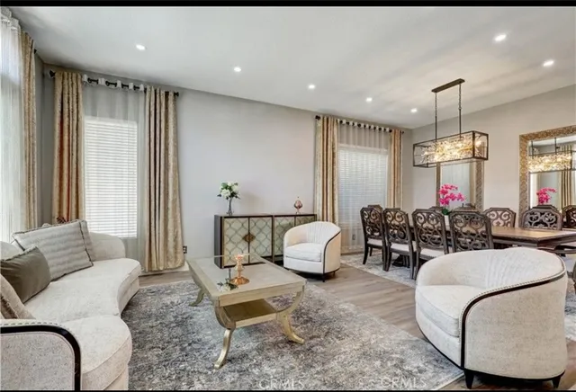 a living room with furniture a large window and a clock