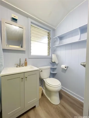 a bathroom with a sink toilet and mirror