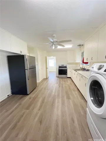 a view of a kitchen with a sink and a refrigerator