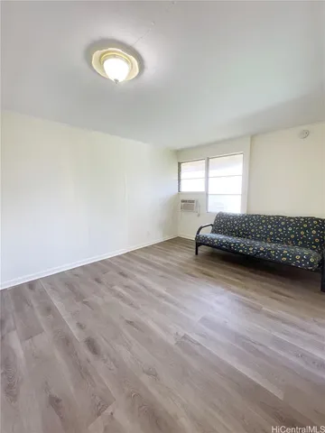 a living room with a bed furniture and a window