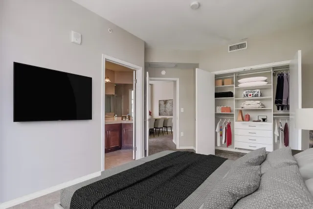 a bedroom with a bed and a flat screen tv