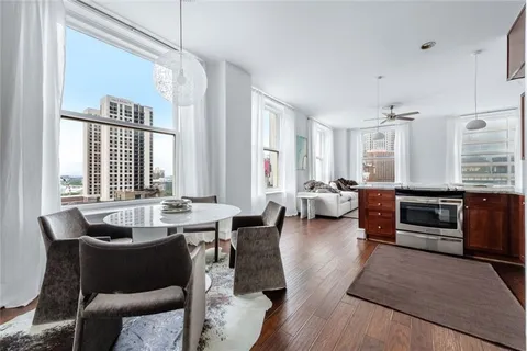 a living room with furniture a large window and a table