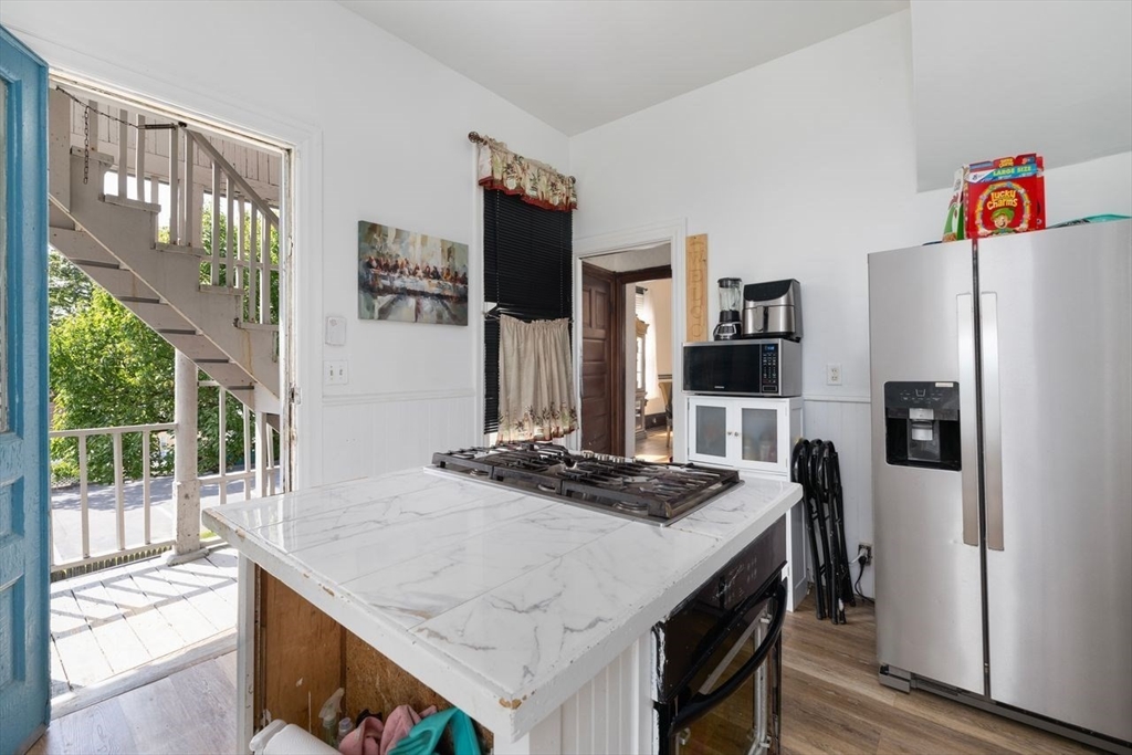 311 Elm Street Woonsocket, RI 02895 - Photo 23 of 29 a kitchen with stainless steel appliances granite countertop a refrigerator and a stove