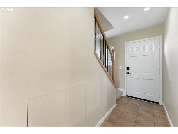 a view of an entryway with wooden floor